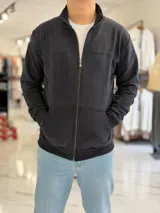 Campera azul marino de felpa con cierre frontal completo, cuello mao, bolsillos tipo canguro y logo bordado en el pecho.
