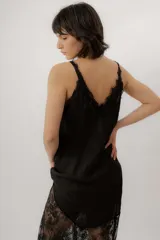 Vestido largo de lino blanco con tirantes finos, escote en V y detalle de encaje transparente en la parte inferior y en el escote.