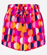 Short de playa con cintura elástica y lazo decorativo. Estampado de lunares grandes en tonos rosa, naranja, amarillo, blanco y violeta.
