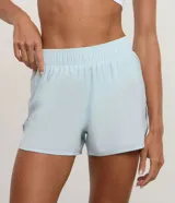 Bermuda deportiva Get Over modelo runner color beige, con cintura elástica, bajo redondeado y aberturas laterales. Cuenta con un pequeño bolsillo funcional trasero.