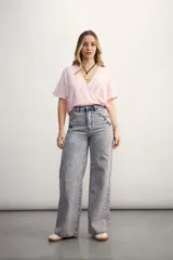 Blusa blanca con diseño cruzado, escote en V y mangas cortas.