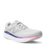 Championes de running New Balance modelo Evoz con tecnología Fresh Foam en la entresuela. Presentan un diseño en color gris claro con detalles en degradado violeta y fucsia en la base, y logo lateral característico.