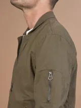 Campera bomber gris claro con cierre frontal y bolsillos laterales.