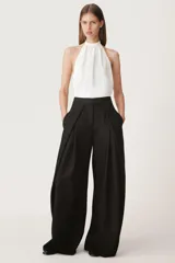 Top blanco de viscosa con cuello halter ajustable con lazadas y espalda descubierta.