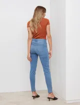 Jean skinny de tiro medio, confeccionado en denim elastizado. Presenta un corte ajustado desde la cadera hasta el tobillo, con diseño clásico de cinco bolsillos funcionales y costuras reforzadas a tono.