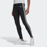 Calza larga de lycra negra con cintura elástica y tres rayas blancas a los costados.