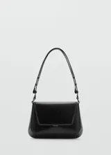 Bolso negro con efecto piel, asa ajustable y cierre de clip metálico. Tiene tamaño medio, asa de hombro y forro interior.