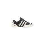 Championes Adidas Y-3 Regu Lace-Up de diseño vanguardista, en color negro y blanco, con detalles de cuero texturizado, las icónicas tres tiras en los laterales y la firma de Yohji Yamamoto.