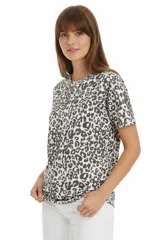 Remera de manga corta y cuello redondo, confeccionada en algodón con estampado animal print en tonos grises y blancos. Presenta un corte holgado y diseño casual.