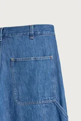 Jeans relaxed fit de mezclilla azul con diseño de bolsillos de carpintero, corte recto y perneras amplias.