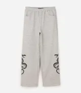 Pantalón de corte super baggy confeccionado en tejido de algodón y poliéster, color gris melange. Presenta un diseño urbano con estampado de serpiente tribal en color negro en las piernas, cintura elástica y bolsillos laterales.