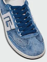 Championes Balmain modelo Swan, confeccionados en denim con efecto desgastado. Presentan el logo de la marca en el lateral en color blanco, cordones azules y suela de goma blanca.