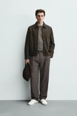 Cazadora regular fit de cuero marrón con efecto lavado vintage, cuello camisero, cierre frontal de cremallera y bolsillos de vivo en la cadera.