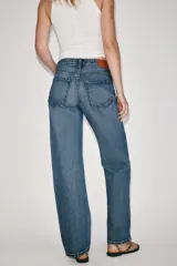Jeans de tiro alto con cinco bolsillos, pernera recta y larga, confeccionados en denim negro con cierre frontal de cremallera y botón metálico.