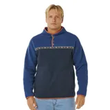 Buzo de polar con diseño color block en tonos azul y azul marino, con cuello alto y cierre frontal parcial con botones a presión. Presenta una franja horizontal con estampado geométrico y bolsillos frontales tipo canguro.