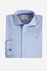 Camisa de manga larga Brooksfield en color celeste con textura tipo piqué. Presenta cuello clásico, cierre frontal con botones y logo bordado en el pecho. El interior del cuello cuenta con un estampado geométrico sutil.