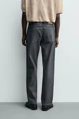 Jeans de corte straight fit, color gris oscuro, confeccionados en denim de algodón rígido, con diseño de cinco bolsillos y cierre frontal con cremallera y botón.