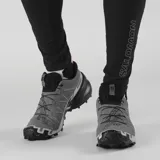 Championes Salomon Speedcross 6 de color negro, diseñados específicamente para trail running. Presentan una estructura robusta y técnica, capellada sintética y textil con refuerzos termosellados, sistema de cordones de ajuste rápido Quicklace y suela con tacos profundos para máxima tracción en terrenos difíciles.