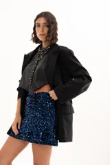 Blazer negro de corte oversize con solapas clásicas, cierre frontal de doble botonadura y bolsillos laterales con solapa.