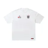 Camiseta de manga corta en color blanco, con diseño de colaboración entre Nike y Palace. Presenta logotipos estampados en el pecho y escudo de la selección de Inglaterra.