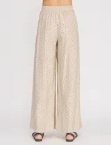 Palazzo de tiro alto color beige con estampado de lunares, cintura elastizada con cordón de ajuste y corte de pierna ancho.