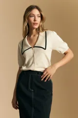 Falda midi negra de denim con costuras blancas contrastantes y tajo frontal.