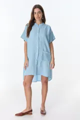 Vestido camisero marrón de lino con mangas cortas, cuello mao, cierre frontal con botones y bolsillo de crochet.