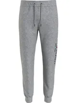 Pantalón de jogging gris melange de Tommy Hilfiger, con cintura elástica ajustable con cordón, bolsillos laterales y logo de la marca bordado en la pierna.