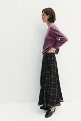 Falda midi de tiro alto con diseño acampanado y estampado de cuadros en tonos negro y marrón. Cuenta con cierre lateral oculto.