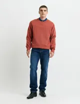Sweater básico de cuello redondo y manga larga, confeccionado en tejido circular con puños y cuello en tejido canalé.