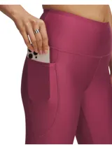 Calza Under Armour color fucsia, de corte capri, con cintura alta antideslizante y tecnología HeatGear®.