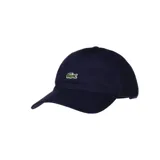 Gorra de béisbol Lacoste color azul marino, con el logo del cocodrilo bordado en el frente.