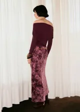 Falda larga de corte evasé confeccionada en tejido jacquard con estampado floral en tonos rosados y bordó. Presenta cintura elástica y forro interior.