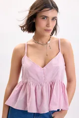 Top sin mangas lila con diseño de broderie, escote en V y detalle de botones frontales decorativos. Presenta tirantes finos regulables y corte peplum fluido.