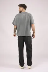 Remera de manga corta, corte oversize, color gris oscuro con efecto lavado o acid wash.