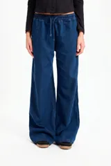 Pantalón de jean azul de corte recto y pierna ancha, con cintura elástica y cordón ajustable.