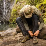 Pantalón negro de corte recto con cintura elástica ajustable con hebilla, bolsillos laterales y traseros con cierre.