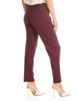 Pantalón de corte recto confeccionado en crepe, con cintura alta y detalle de botones metálicos dorados decorativos en los laterales. Presenta una silueta estructurada y elegante.