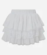 Pollera corta de algodón color blanco, con volados en capas y detalles de encaje floral.