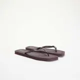 Chanclas de dedo color bordó con suela plana y tiras finas texturizadas.