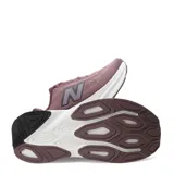 Championes New Balance Kaiha de mujer, color rosado con entresuela blanca y rosada clara, y suela marrón. Presenta el logotipo "N" característico en los laterales.