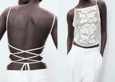 Top de crochet color blanco con diseño entallado, espalda abierta con cierre de lazo y tirantes finos.
