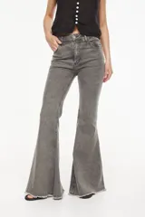 Jeans de corte acampanado y cintura alta, color gris con efecto acid wash y acabado deshilachado en el ruedo.