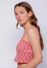 Top tejido con pequeños calados, sin mangas, con tirantes finos y escote recto.