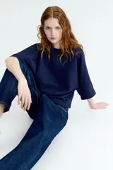 Remera oversized de felpa liviana color azul marino, con cuello redondo ribeteado y mangas anchas al codo.