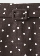 Falda midi evasé de tiro medio, confeccionada en mezcla de lino, con estampado de lunares y detalle de cinturón en la cintura.