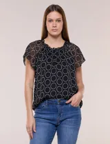 Blusa holgada de gasa negra con estampado geométrico de círculos blancos, cuello redondo fruncido con volados y mangas cortas de corte mariposa.