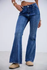 Jean de corte oxford con tiro medio-alto, confeccionado en denim azul con costuras verticales frontales que estilizan la silueta.