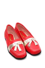 Mocasín de cuero negro con detalle de antifaz plateado y borlas.