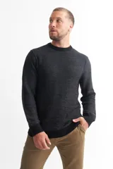 Sweater de punto melange color gris oscuro, con cuello redondo y mangas largas.